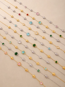 Detail of colorful glass stone necklaces with gold and silver bead chains in various colors