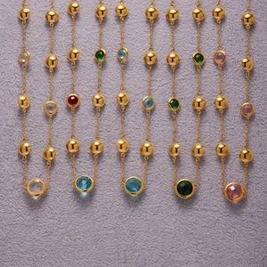 Golden necklace with multicolored faceted gemstones and polished beads on delicate chains