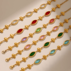 Detail of colorful marquise crystal bracelets with golden heart links and lobster clasps
