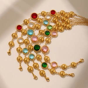Detailed macro of gold stainless steel anklets with vibrant colored crystals