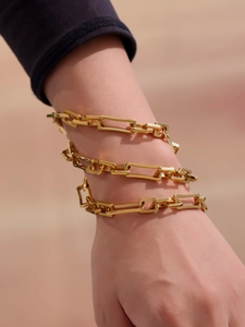 Nahaufnahme des vergoldeten Edelstahl-Gliederarmbands am Handgelenk eines weiblichen Models