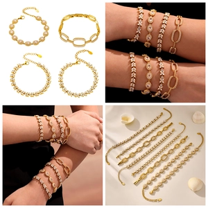 Detailed views of gold clover bracelets with zircons including close-ups and layered styling