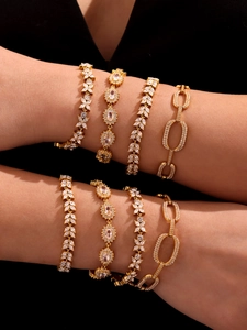 Close-up of four luxury 18K gold plated zircon bracelets worn together by a model