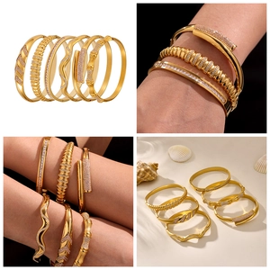 Detail view of 18k gold plated stainless steel bangles set with sparkling zircons