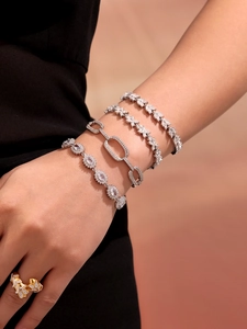 Detail showing tiered silver bracelets with 5A zircons and a gold butterfly ring