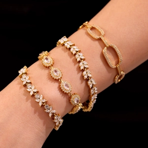 18K gold plated geometric bracelets set with sparkling cubic zirconia on a model arm