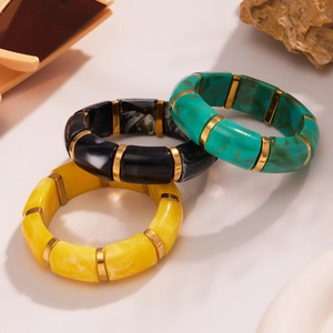 Three-piece stretch resin bracelet set with marble textures in yellow, black, and emerald
