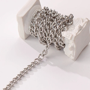 DIY silver twisted curb chain necklace wrapped around a vintage white decorative pillar