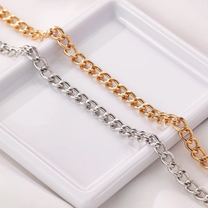 Curb chain link necklaces in gold and silver finish on a ceramic plate for DIY projects