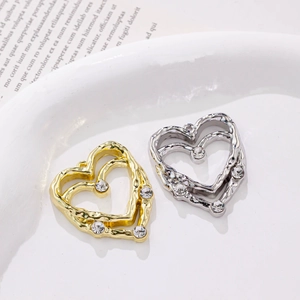 Irregular textured double-layered heart pendants in gold and silver with zircon accents