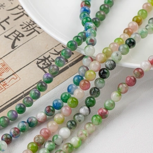 Macro detail of mixed color natural stone beads with marble texture for DIY jewelry