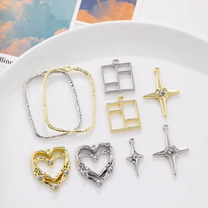 Macro view of geometric gold and silver DIY jewelry pendants with sparkling rhinestones
