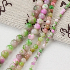 Detailed view of mixed green and pink natural jade beads for DIY jewelry making