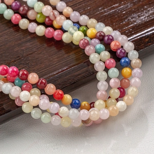 Macro detail of multi-colored natural jade round beads for DIY handmade jewelry crafts
