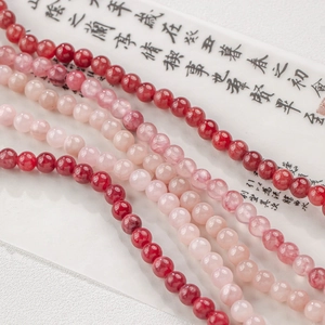 Makroaufnahme von 4-12mm rosaroten Jadeperlen in Verläufen von Pink bis Dunkelrot