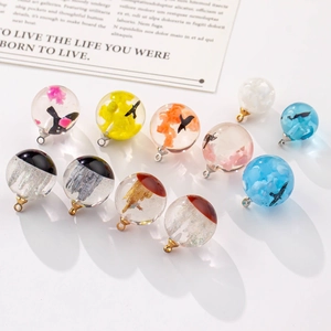 DIY handmade spherical resin pendant with colorful clouds and flying birds inside