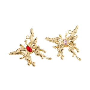 Golden butterfly pendant with red and pink gemstones featuring liquid metal texture