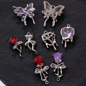 Detailed shot of retro silver alloy butterfly and liquid heart charms for DIY jewelry making