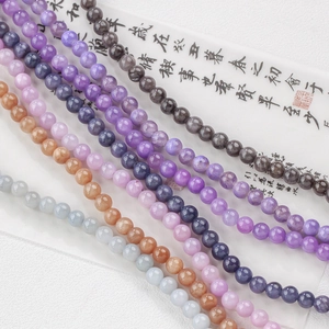 Macro shot of 6-8mm colorful natural gemstone beads in purple, orange and blue for DIY jewelry
