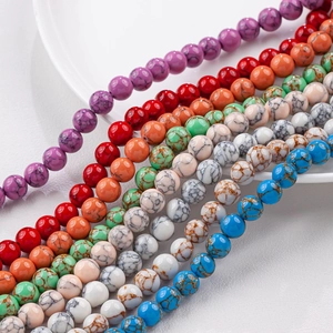 Detailed close-up of colorful round turquoise style beads showing natural marble textures