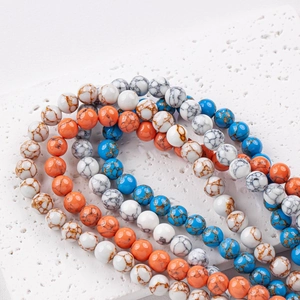 DIY jewelry beads with marble texture in white, orange, and blue finishes