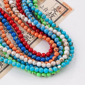 Cuentas redondas de concha y turquesa para joyería DIY sobre papel de caligrafía