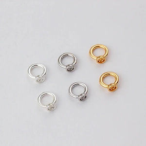 DIY jewelry connectors for bracelets in 18k gold and silver finish on grey background