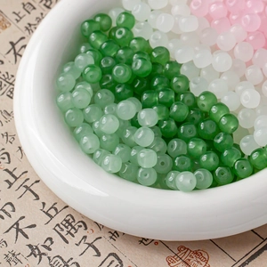 Macro view of multi-colored translucent glass beads for DIY jewelry on calligraphy paper