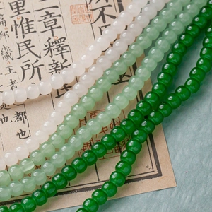Macro view of four green gradient glass beads strands for Chinese style DIY jewelry making