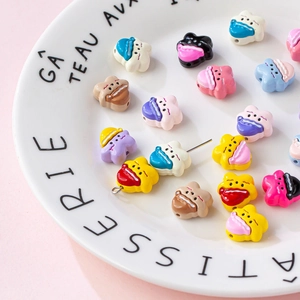 Colorful cartoon star and nightcap alloy pendants for DIY jewelry making in a ceramic bowl