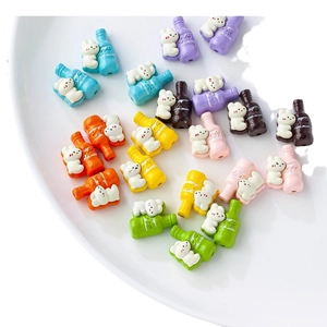 Cute bunny holding bottle DIY bead accessories in assorted vibrant colors on white tray