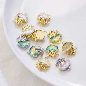 Detailed view of iridescent jellyfish charms with gold and silver alloy frames for DIY jewelry