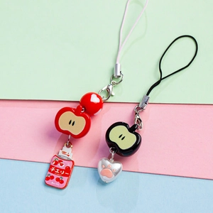 Detail of red and black acrylic apple charms and fruit pendants for DIY jewelry making