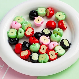 Colorful apple-shaped acrylic beads for DIY jewelry making displayed in a white bowl