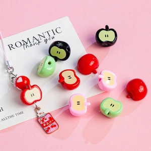 Detailed view of apple-shaped acrylic beads and soda can pendant for DIY crafts