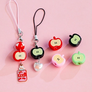 Detail of colorful acrylic apple beads and cherry can pendant for DIY phone lanyards