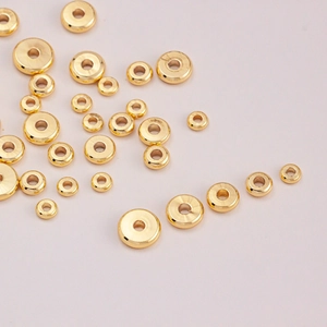 Macro shot of 14K gold plated donut spacer beads in various sizes for DIY jewelry