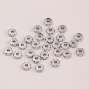 Close-up of polished silver spacer beads for DIY jewelry making and handmade crafts
