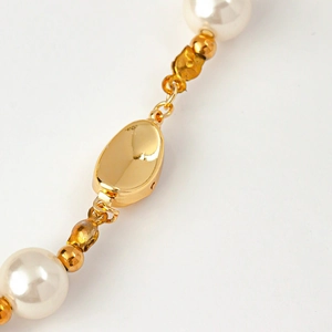 Macro detail of 18k gold plated clasp connector for handmade pearl necklace and bracelet