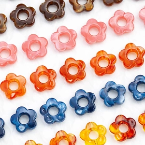Macro detail of 14mm marbled acrylic flower charms for DIY jewelry and hair accessories