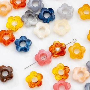 Macro detail of 14mm marbled acrylic flower beads with center holes for DIY jewelry