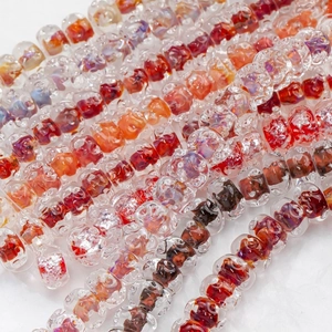 Close-up of 12mm wavy glass lampwork beads in assorted amber and silver glitter colors