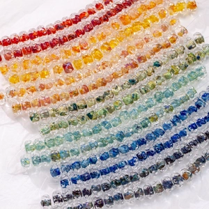 Close-up of translucent 12mm lampwork glass beads with colorful inner swirl textures