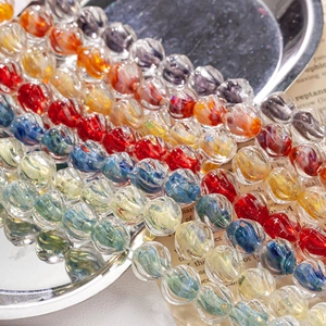 Detailed close-up of colorful spiral lampwork glass beads for DIY jewelry making