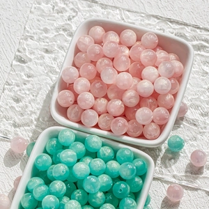 Macro shot of 8-10mm translucent pink and mint green beads for DIY jewelry making