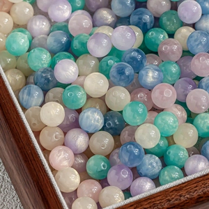 Macro detail of mixed macaron cat eye beads with pearlescent finish for DIY jewelry
