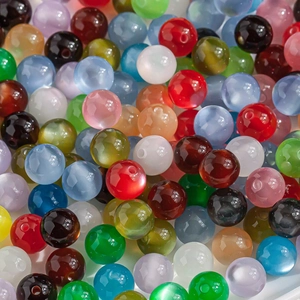 Macro shot of 10mm iridescent cat eye resin beads with faceted cuts for DIY jewelry making