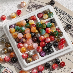Colorful 10mm resin beads with cat eye luster for DIY jewelry making in a white tray
