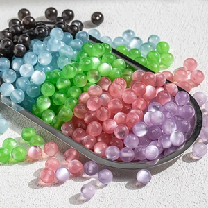 Colorful 10mm cat eye resin beads in a silver tray for DIY jewelry making and crafts