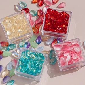 Close-up of gradient glass teardrop beads for DIY hairpins in sorted plastic containers